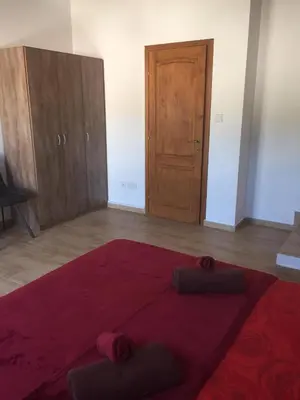 a room with a red rug and a wooden door at Love Holiday Suite 1 in Tris Elies