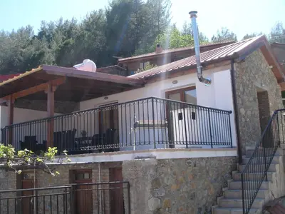 a small house with a balcony and stairs at Love Holiday Suite 1 in Tris Elies
