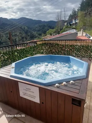 a jacuzzi tub on a deck with a view at Love Holiday Suite 2 in Tris Elies