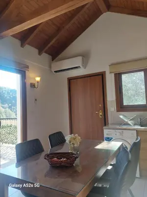 a kitchen with a table with chairs and a counter top at Love Holiday Suite 2 in Tris Elies