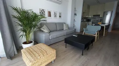 a living room with a couch and a table at Sunorama Waterfront Apartment in Larnaka