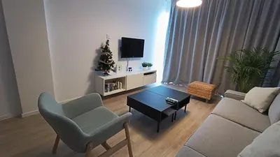a living room with a couch and a table at Sunorama Waterfront Apartment in Larnaka