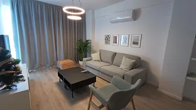 a living room with a couch and a table at Sunorama Waterfront Apartment in Larnaka