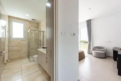 a bathroom with a shower and a toilet and a sink at Seafront Villa Cecelia by Ruidoso Luxury in Ayia Napa