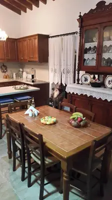 a kitchen with a wooden table with vegetables on it at Xenios Cottages in Lofou