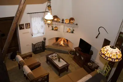 an overhead view of a living room with a fireplace at Xenios Cottages in Lofou