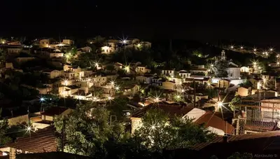 a view of a city at night with lights at Xenios Cottages in Lofou
