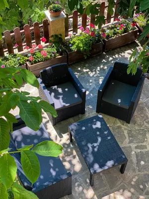 a patio with two chairs and some plants at Magdalous House in Arsos
