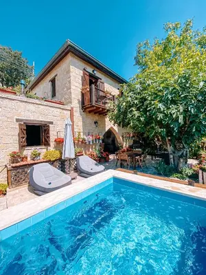 a swimming pool in front of a house at Magdalous House in Arsos