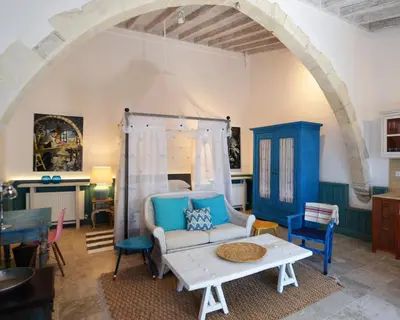 a living room with a couch and a table at Apokryfo Traditional Guesthouse in Lofou
