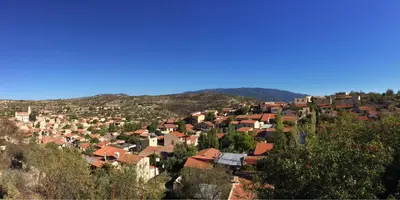 a view of a town with houses and trees at Apokryfo Traditional Guesthouse in Lofou