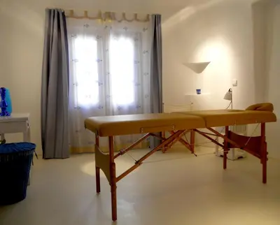 a wooden table in a room with a window at Apokryfo Traditional Guesthouse in Lofou