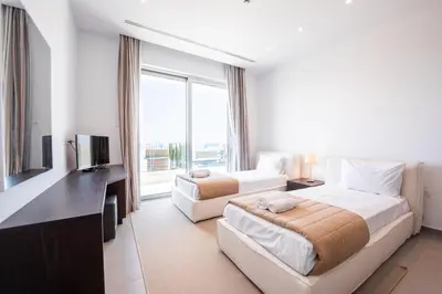 a hotel room with two beds and a television at Villa Marsali by Ruidoso Luxury in Ayia Napa