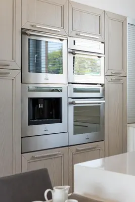 a kitchen with stainless steel ovens and windows at Villa Marsali by Ruidoso Luxury in Ayia Napa