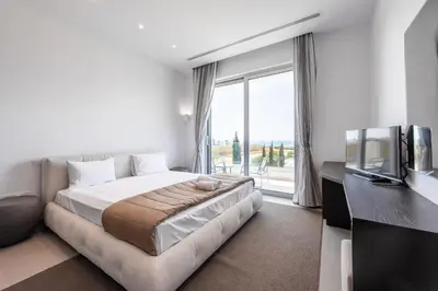 a bedroom with a large bed and a large window at Villa Marsali by Ruidoso Luxury in Ayia Napa