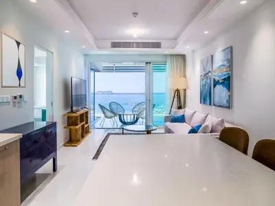 a kitchen and living room with a view of the ocean at The Tower at St Raphael Resort in Limassol