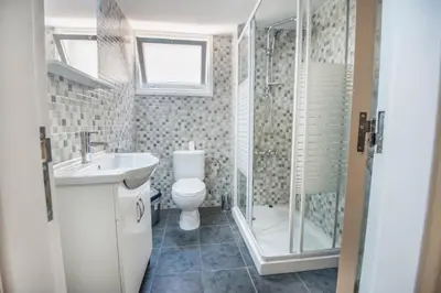 a bathroom with a toilet and a sink and a shower at Orion Apartment 401 in Larnaka