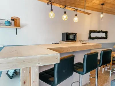 a kitchen with a wooden table and chairs at Milea Mansion in Limassol