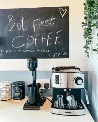 a coffee maker on a counter with a chalk board at Milea Mansion in Limassol