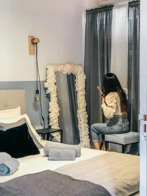a woman brushing her hair in a bedroom at Milea Mansion in Limassol