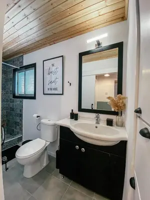 a bathroom with a sink and a toilet and a mirror at Milea Mansion in Limassol