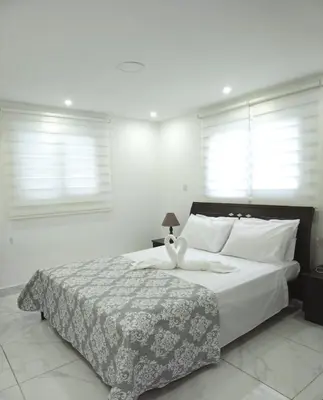 a bedroom with a bed with two stuffed animals on it at Seafront - 2 bedroom Modern in Limassol