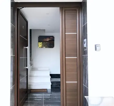 a glass door leading to a hallway with stairs at Seafront - 2 bedroom Modern in Limassol