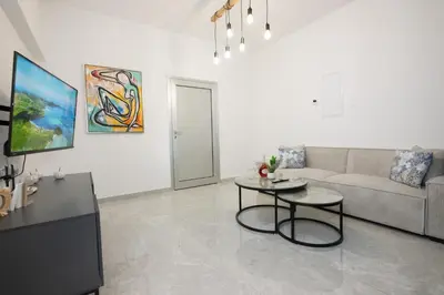 a living room with a couch and a table at Bellagio Napa Suites in Ayia Napa