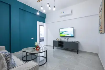 a living room with a table and a sink at Bellagio Napa Suites in Ayia Napa