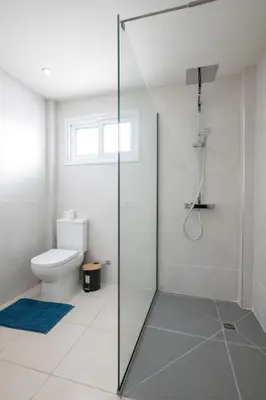 a bathroom with a shower and a toilet at Bellagio Napa Suites in Ayia Napa