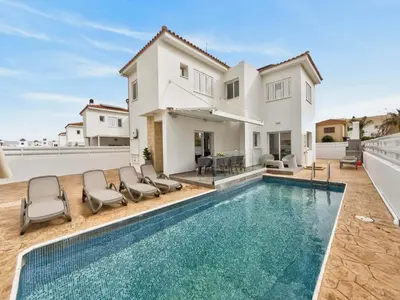 a villa with a swimming pool and a house at Elite Luxury Villa in Paralimni