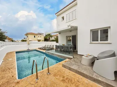a swimming pool in the backyard of a house at Elite Luxury Villa in Paralimni