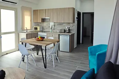 a kitchen and dining room with a table and chairs at Ayia Napa Boutique Apartments in Ayia Napa