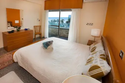 a bedroom with a large bed and a window at Limassol Hestia Boutique Apartment in Limassol