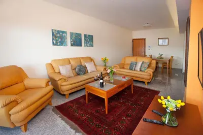 a living room with two couches and a coffee table at Limassol Hestia Boutique Apartment in Limassol