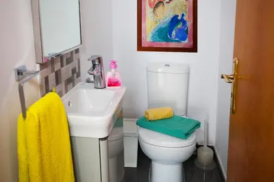 a bathroom with a white toilet and a sink at Limassol Hestia Boutique Apartment in Limassol