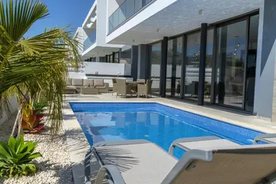 a swimming pool in the backyard of a house at Protaras Royal Pearl Villa 7 in Protaras