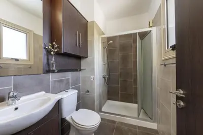a bathroom with a toilet and a sink and a shower at Protaras Palm Villa 54 in Protaras