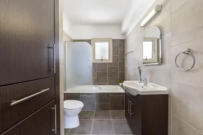a bathroom with a toilet and a sink and a tub at Protaras Palm Villa 54 in Protaras