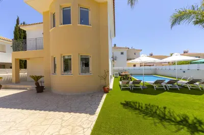 a villa with a swimming pool and a yard at Protaras Palm Villa 54 in Protaras