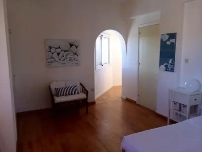a room with a bed and a chair and a window at Villa in Ayia Napa with a pool! in Ayia Napa