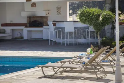 a group of chairs sitting next to a swimming pool at Villa in Ayia Napa with a pool! in Ayia Napa