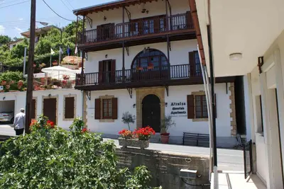 a building with a balcony on the side of it at ATRATSA Mountain Suites in Kalopanayiotis