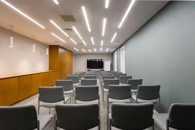 a room with rows of chairs and a podium at Radisson Beach Resort Larnaca in Larnaka