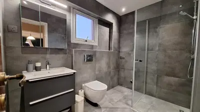 a bathroom with a shower and a toilet and a sink at Nissi Golden Sands Lome in Ayia Napa