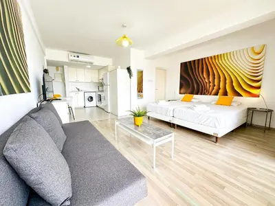 a living room with a couch and a table at Lovely Studio Ayia Napa in Ayia Napa