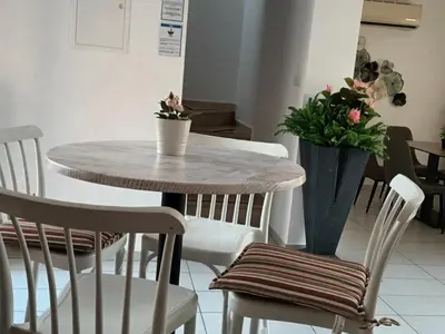 a table and chairs with flowers on top of it at PERNERA 33 Beach House in Protaras