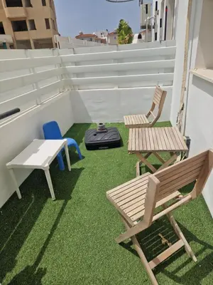a balcony with two chairs and a table and a bench at PERNERA 33 Beach House in Protaras