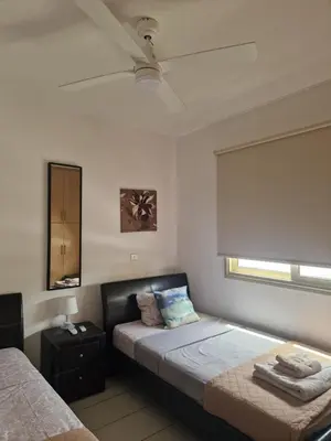 a bedroom with a bed with a ceiling fan at PERNERA 33 Beach House in Protaras