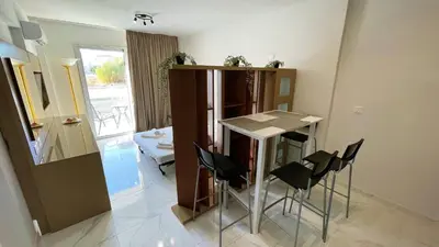 a small kitchen with a table and chairs in a room at Fotoxenia Luxury Apts in Paralimni